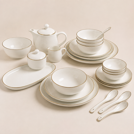 Tableware set with white ceramic plates, bowls, teapot, and serving pieces.